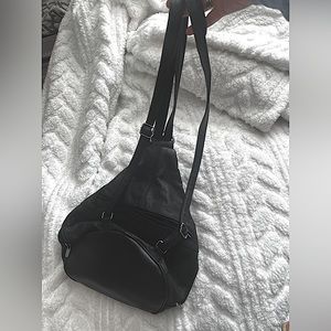 Black Leather material multiple pockets.can a be back pack or over the shoulder